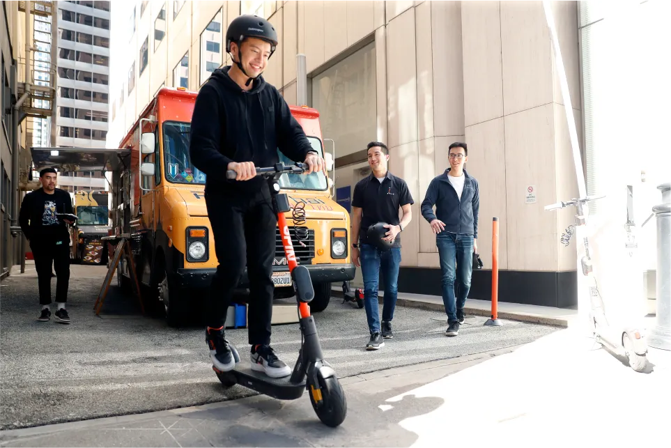 Someone riding a spin scooter away from a food truck
